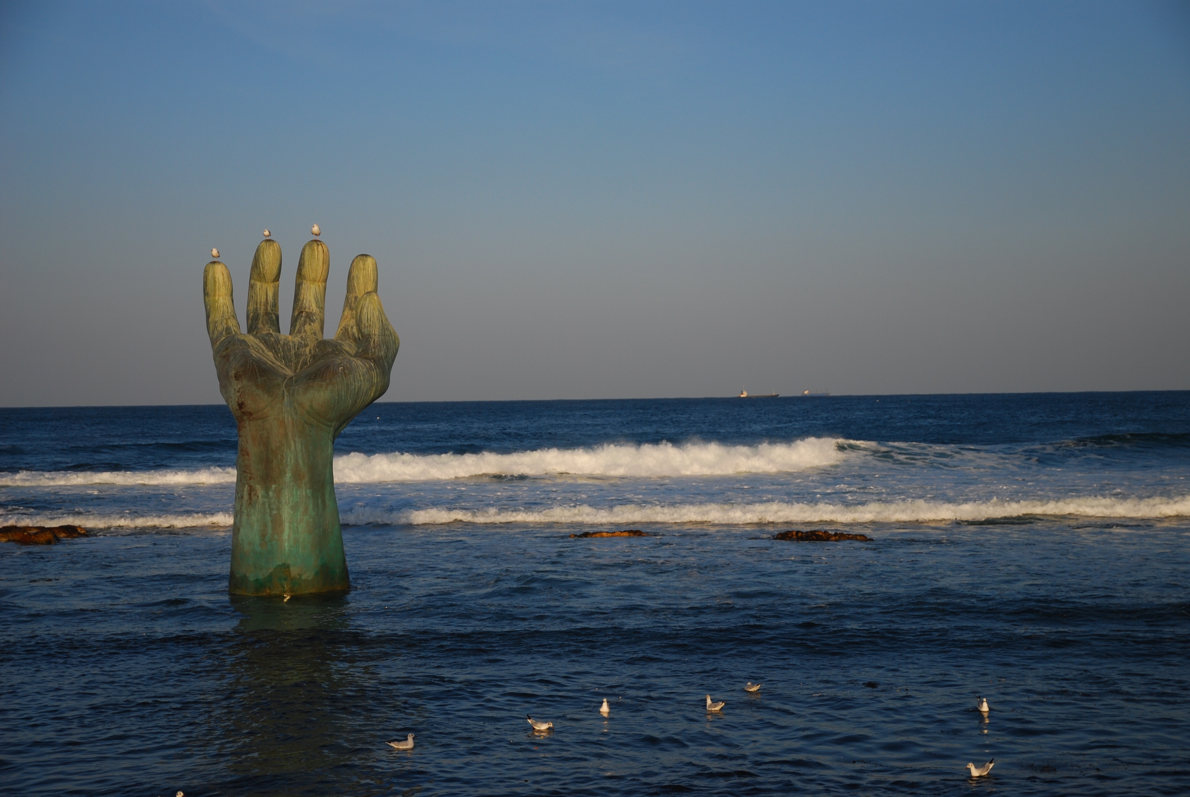 Hand in sea as a sculpture free image download