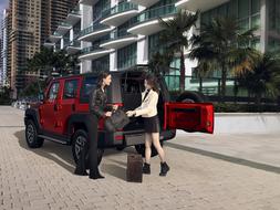 girls near a red car