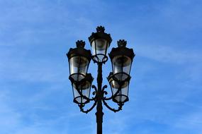 street lamp against a blue sky