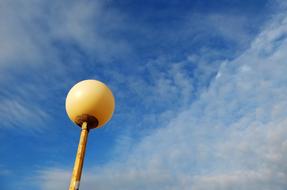 yellow lantern against the clouds