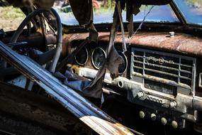Rusty forgotten car on the street