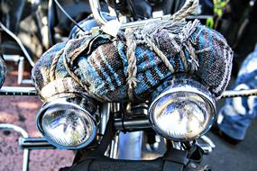 colored bag tied to a motorcycle