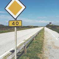 sign by the road in the field