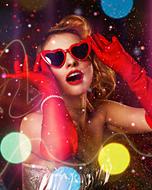 Girl with red heart glasses and in colorful clothing, among the bokeh lights