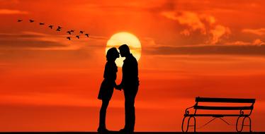 lovers kiss in orange sunset