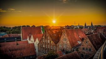 red clay tile roofs of old buildings in center of city at dusk, germany, lÃ¼beck