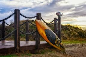 Surfboard leaning on fence