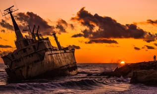 abandoned ship at sunset
