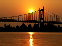Brooklyn Bridge against the golden sky in New York