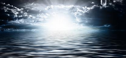bright setting sun over the waves of the ocean
