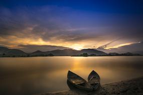 two Boats on Sea Coast at scenic sunrise