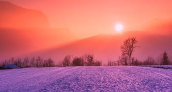 scenic Winter sunrise, purple Snow beneath red sky on the beautiful landscape