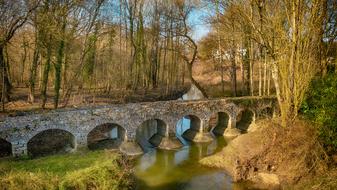 pedestrian stone bridge over the river in Breau, France