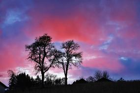 pink clouds over blue sky over countryside
