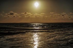 photo of the ocean against the evening sun