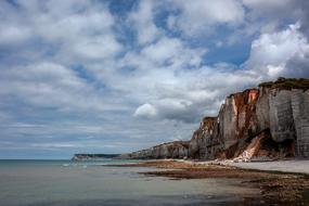 rocks on the ocean against the backdrop of clouds