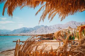 view from the thatched canopy to the sunny seaside