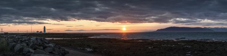 photo of a lighthouse on a rocky coast in Iceland