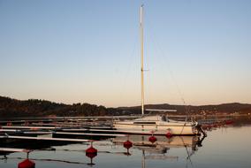 sailboat in quiet harbor at dusk