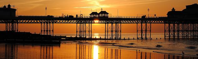 Pier near the ocean at sunset time