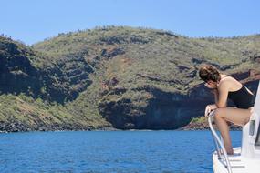 Wonderful view with the girl on the boat looking on the shore