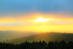 painted yellow sunset over a green hill
