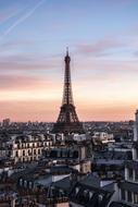 panoramic photo of the roofs of buildings in Paris and the Eiffel Tower