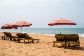 deck chairs with parasols on the beach