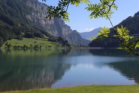 Beautiful landscape of the KlÃ¶ntal lake, among the green mountains in Switzerland