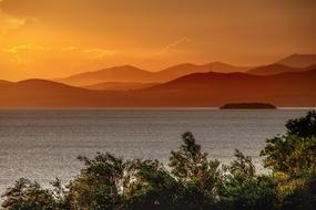 mountains near the sea at dusk