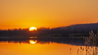 yellow sunset reflected in calm water