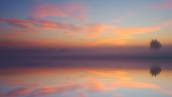 romantic sunset reflected in a calm lake