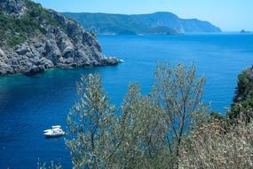 white boats on blue Sea at scenic rocky Coast