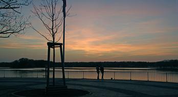 People on the beautiful landscape of the shore, at colorful sunset