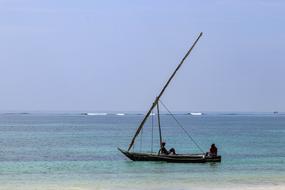 fisherman in a boat at sea on the shore of Diani Beach, Kenya