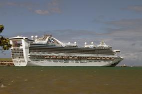 distant view of white cruise ship on a sunny day