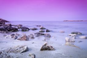 stones on the shore in waves