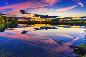 colorful sky reflected in a quiet lake at sunset