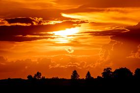orange-fiery sunset over the black forest