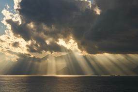 sunny sunset in gray dark clouds