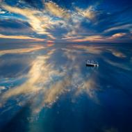 reflection of evening clouds in a calm sea