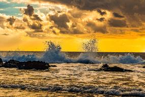 Wave Smashing Rocky Coast in the yellow twilight