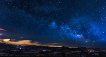 the milky way in the night sky over the mountains