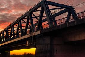 Beautiful bridge, at colorful, gradient sunset in the sky with clouds