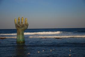 hand in sea as a sculpture