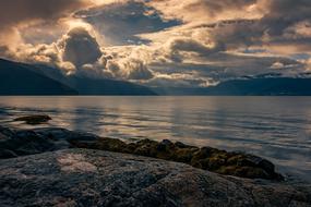 scenic sunset above calm sea at Fjord