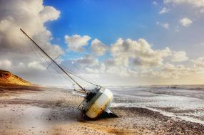 sailing boat on the beach after wreck