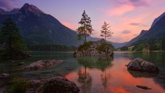 red evening sky reflected in a mountain lake