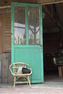 vintage armchair at open wooden door