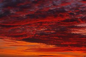 heavy orange clouds in the evening sky